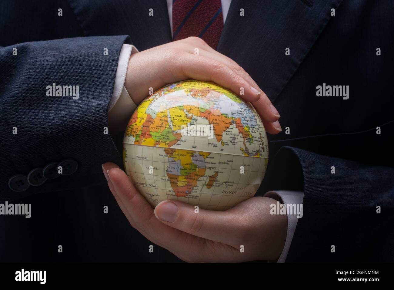 Businessman is standing with an earth globe fot business concept Stock ...