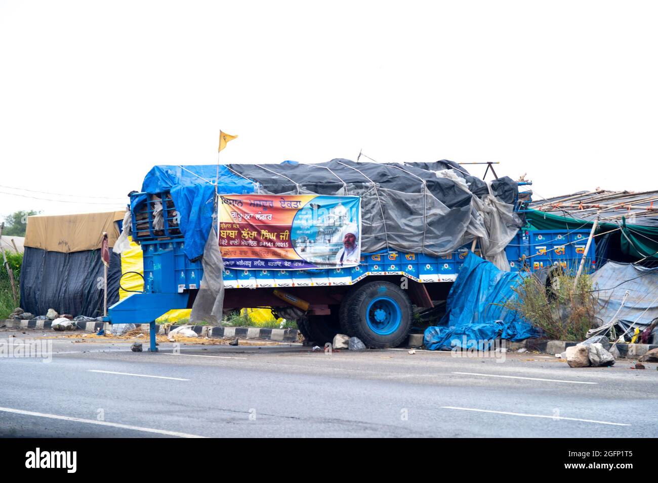 temporary shelter made from a tractor trolley covered with plastic wrap