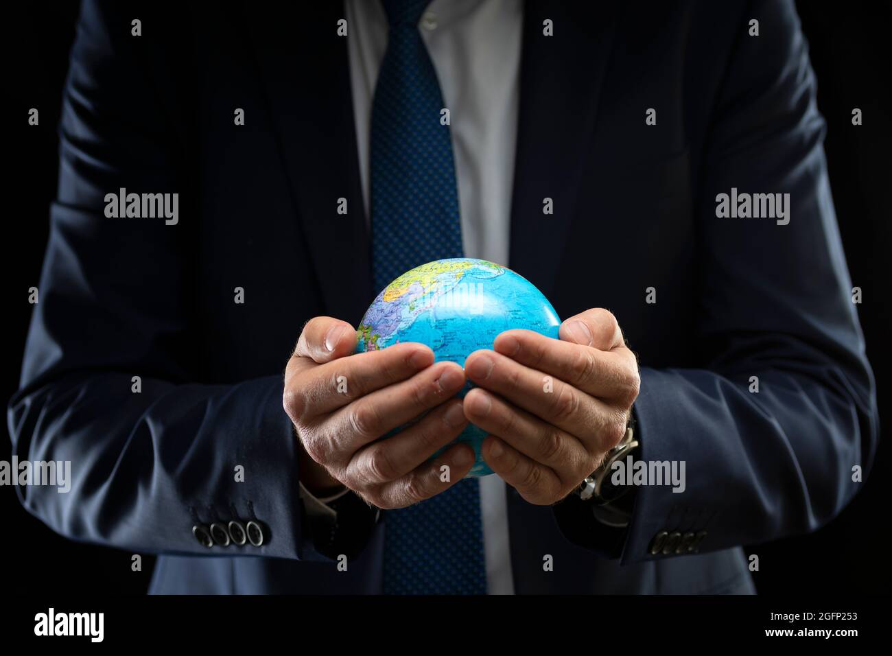 Black white hands holding globe hi-res stock photography and images - Alamy