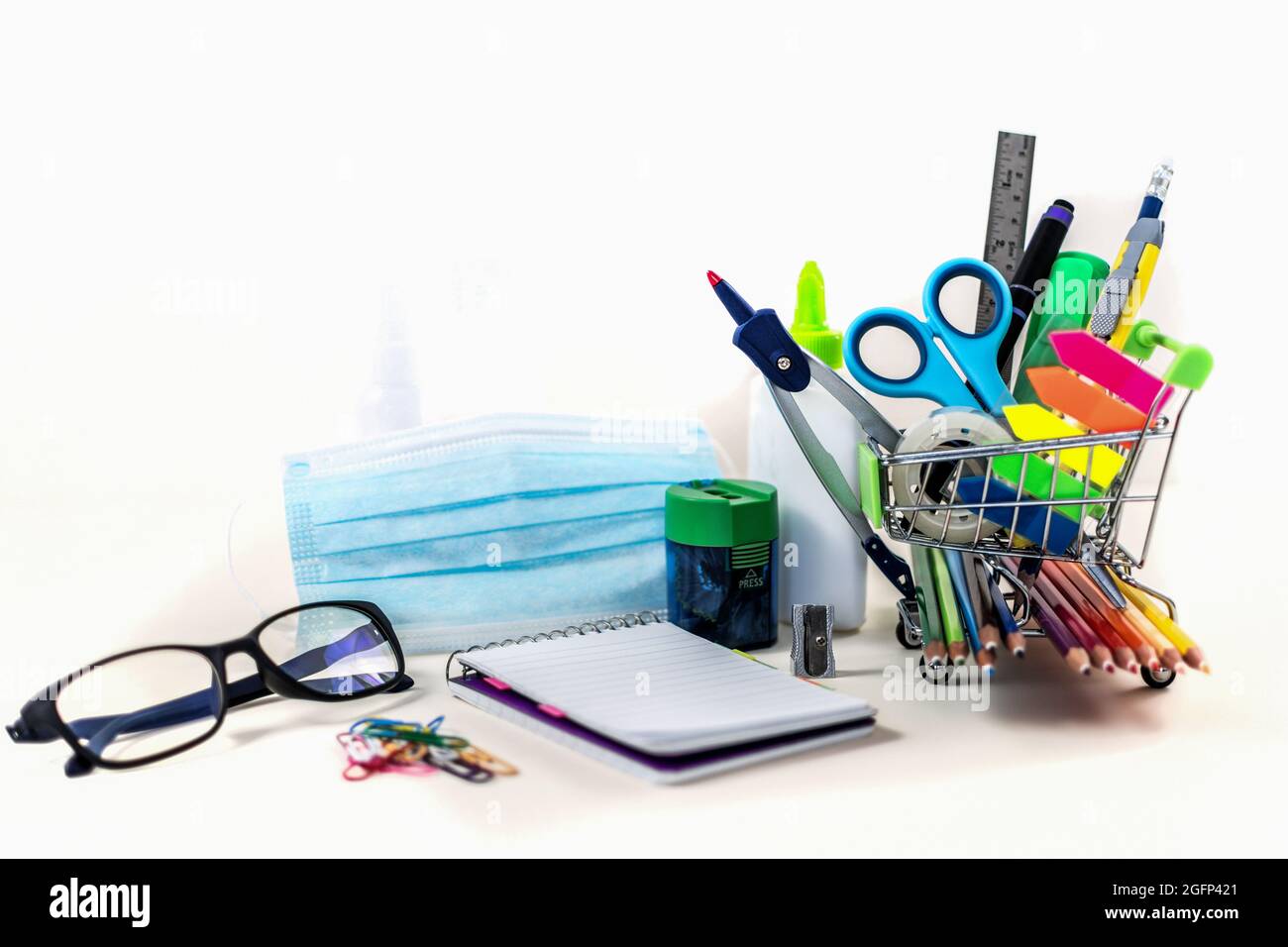 Vertical shot of school and office supplies on white background Stock Photo