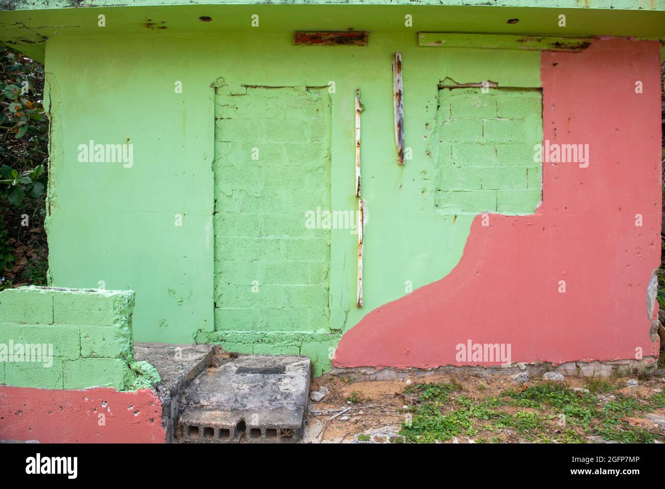 A worn down house painted in green and pink - Puerto Rico Stock Photo