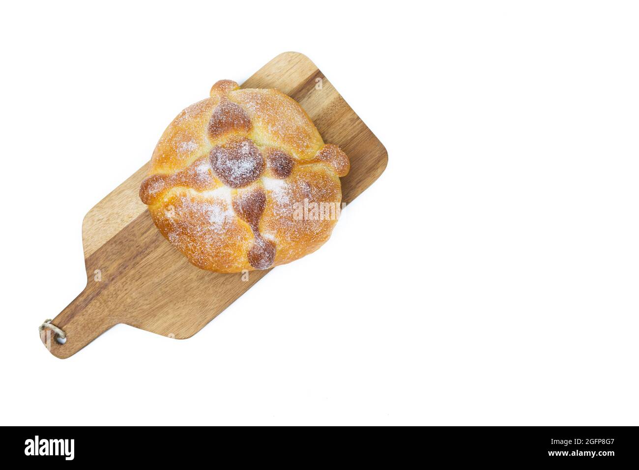 Pan de muerto on yellow background, typical mexican food. Day of the dead celebration. Copy space. Top view. Stock Photo