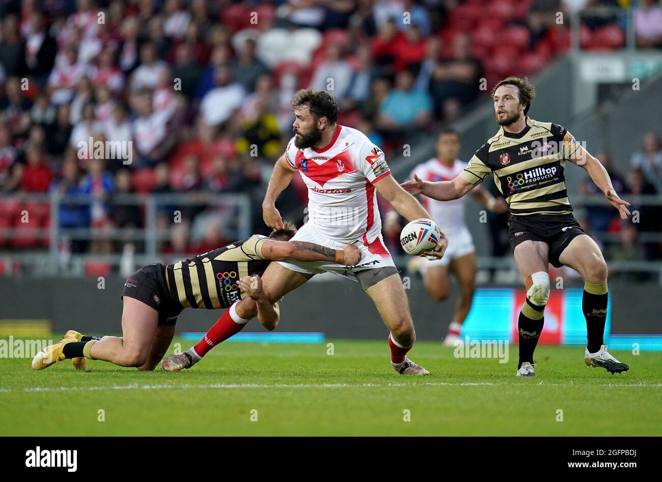 St Helens’ Alex Walmsley is tackled by Leigh Centurions’ Keanan Brand during the Betfred Super League match at the Totally Wicked Stadium, St. Helens. Picture date: Thursday August 26, 2021. Stock Photo