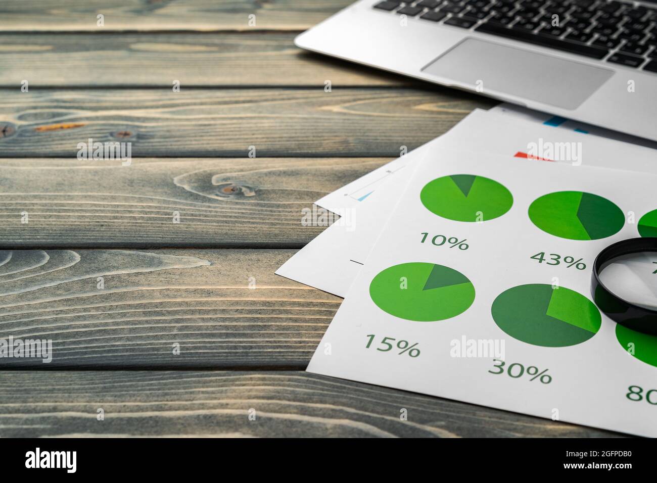 Financial report and laptop on business desk Stock Photo - Alamy