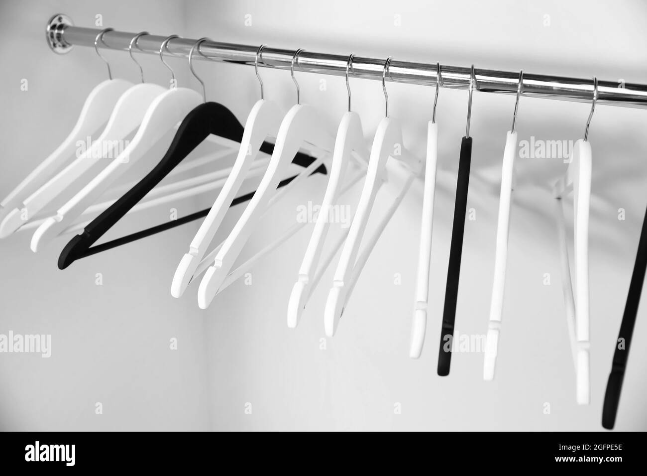Clothes hangers in empty wardrobe, closeup Stock Photo Alamy