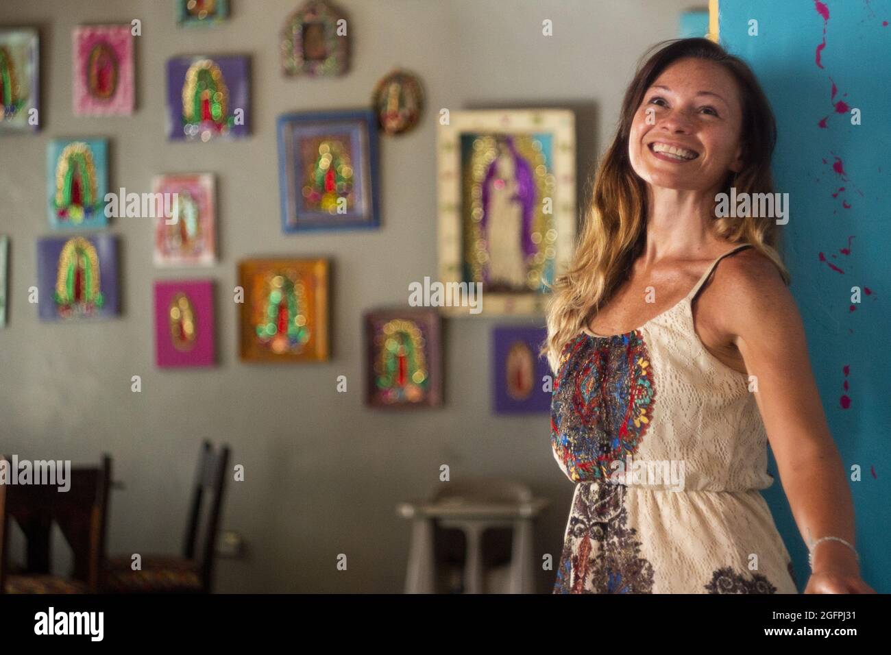 Shallow focus of a smiling Hispanic woman wearing a dress Stock Photo