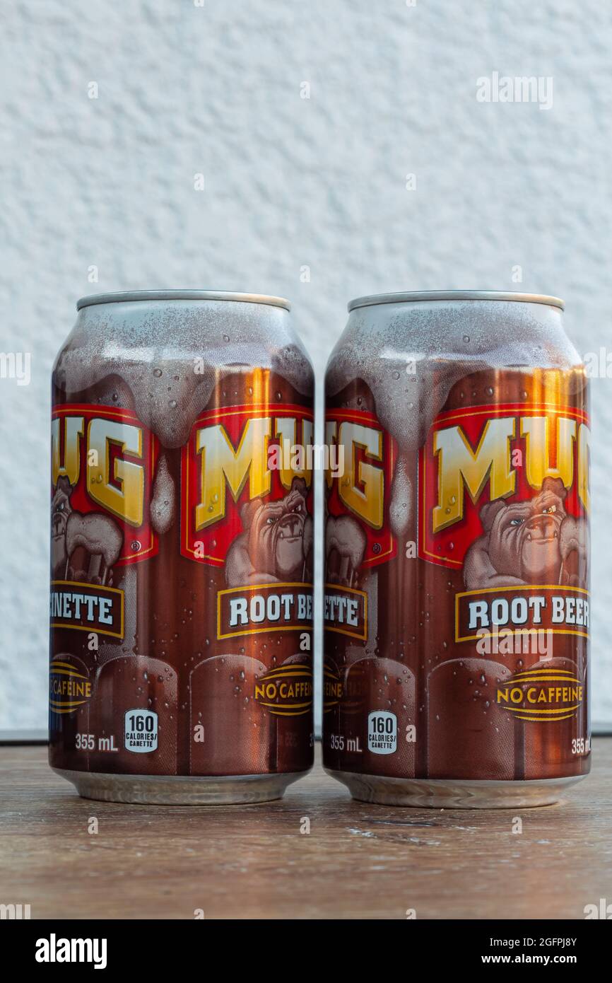 Mug Root beer soft drink product. Two cans of Root Beer on the table. Illustrative editorial, selective focus, street view, travel photo. Surrey BC, Stock Photo