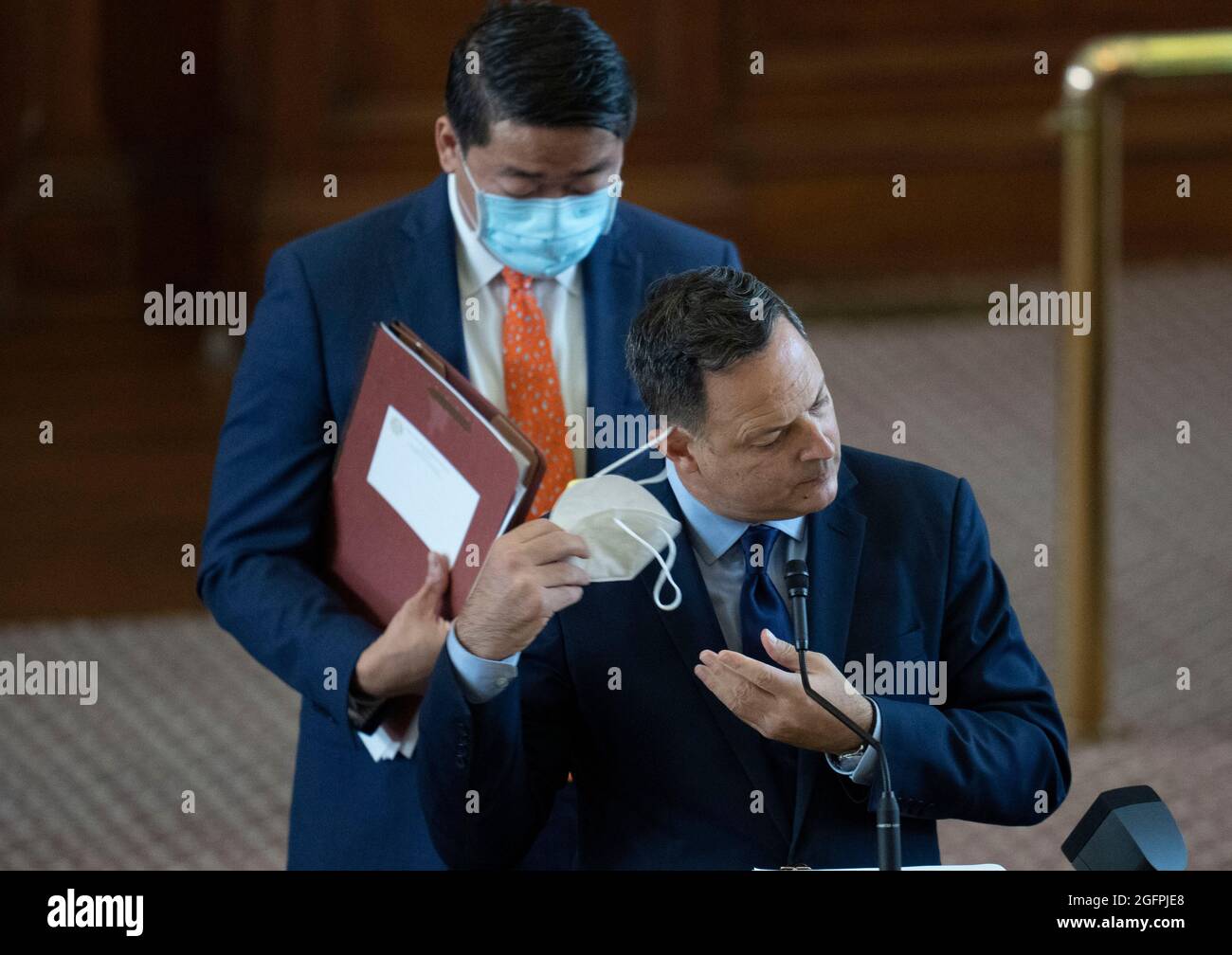 Austin Texas USA, Aug. 26, 2021: Rep. Rafael Anchia, D-Dallas, removes his mask as the Texas House debates SB 1, a Republican-led measure that would tighten voting procedures in Texas including a ban on 24-hour voting and mail-in ballot restrictions. In the back is Rep. Gene Wu, D-Houston. Credit: Bob Daemmrich/Alamy Live News Stock Photo