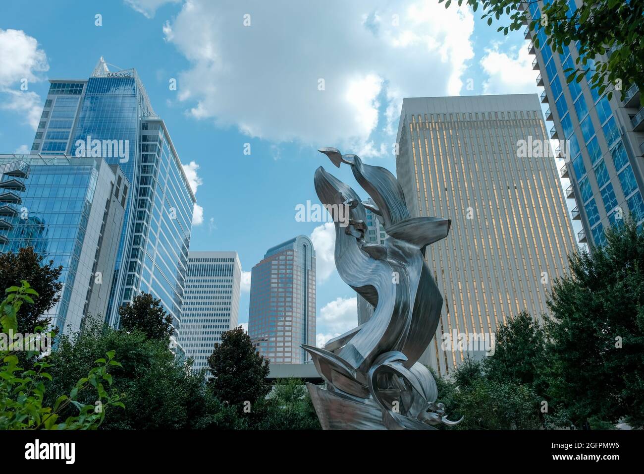 Charlotte, North Carolina, USA - August 24, 2021: Modern sculpture framed by city skyline at Romare Bearden Park Stock Photo