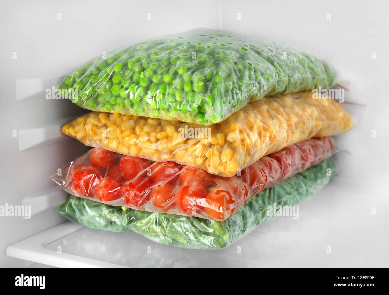 Containers and plastic bags with vegetables in refrigerator Stock Photo   Alamy