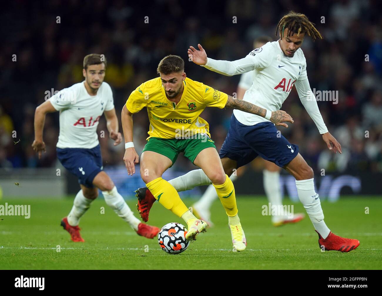 Pacos de Ferreira's Helder Ferreira (left) and Tottenham Hotspur's Dele Alli battle for the ball during the UEFA Europa Conference League Play-offs, second leg match at the Tottenham Hotspur Stadium, London. Picture date: Thursday August 26, 2021. Stock Photo