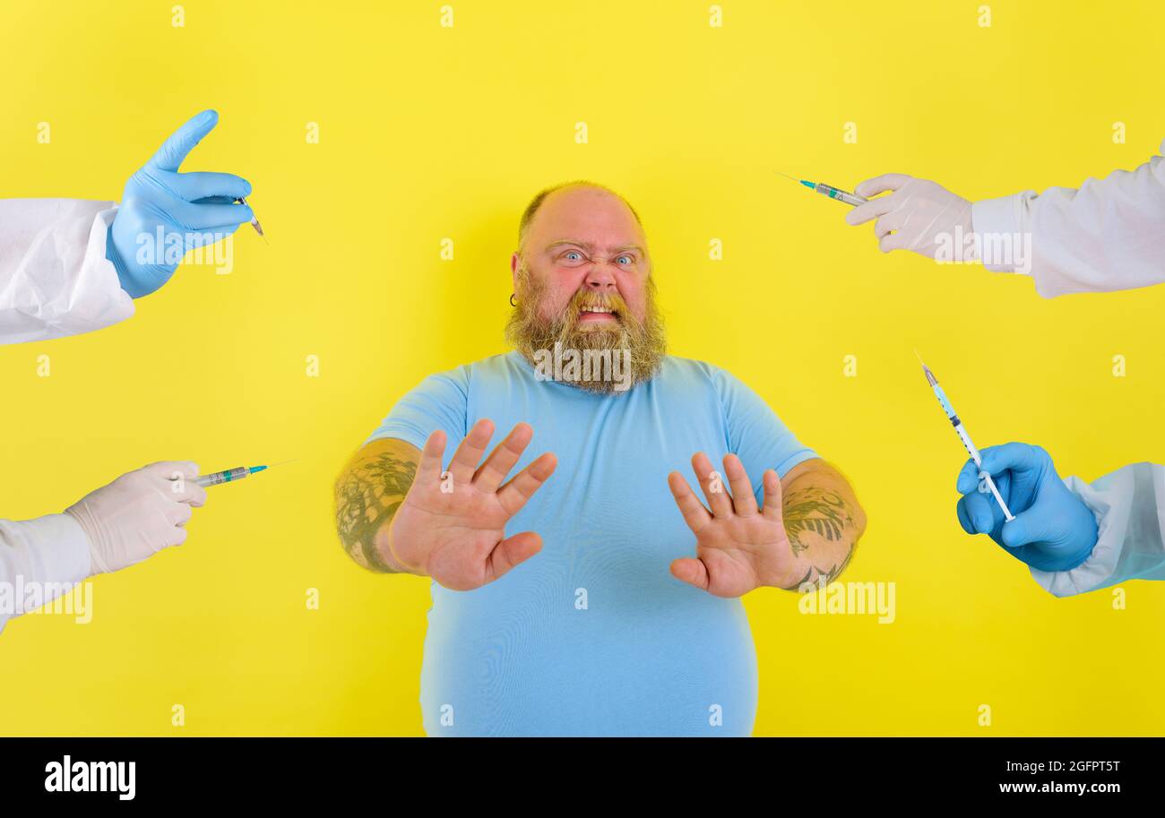 Fat doubter man has doubts about covid-19 vaccine Stock Photo