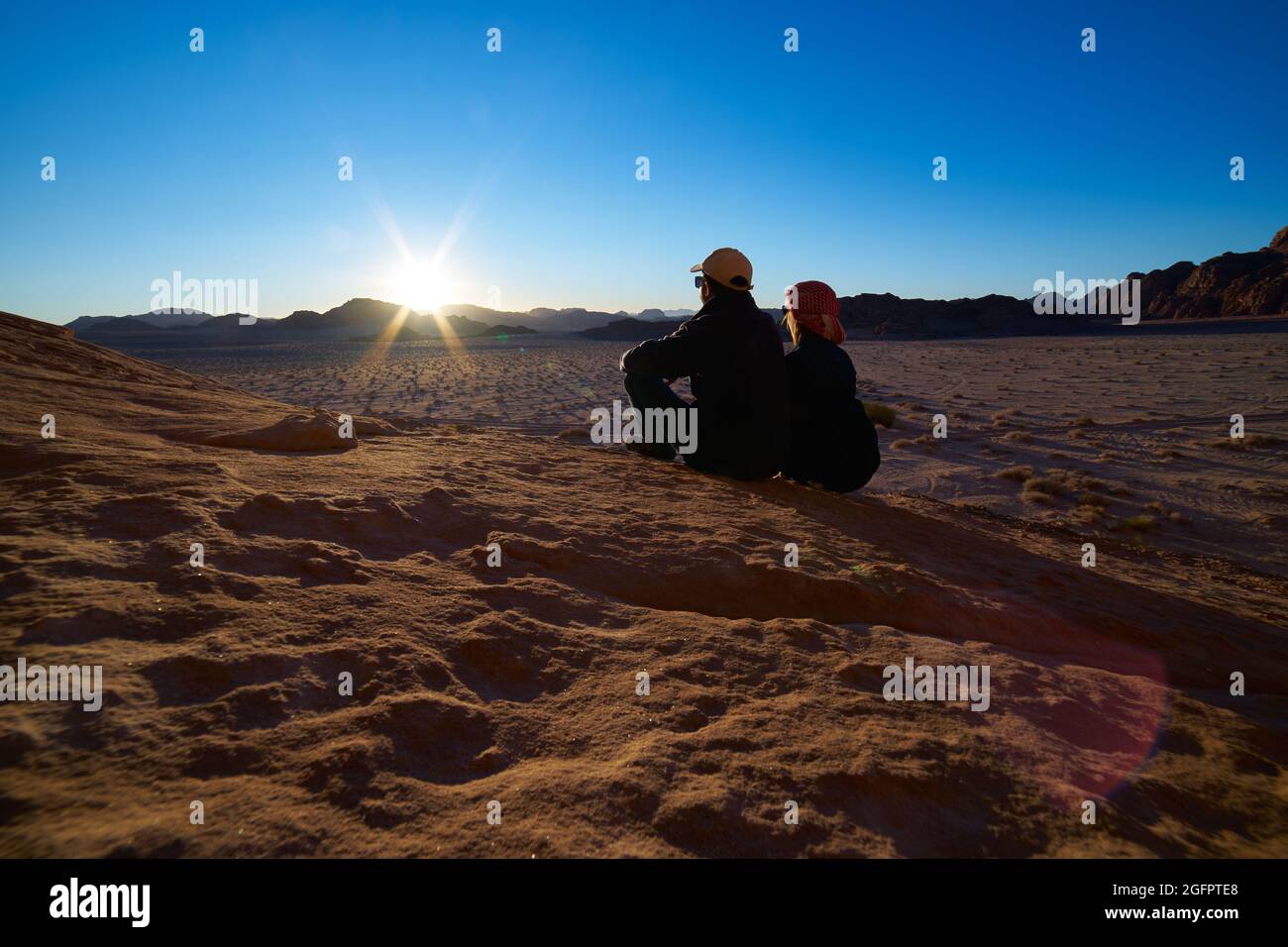 me and my wife silhouette watching sunset in jordanian wadi rum des
