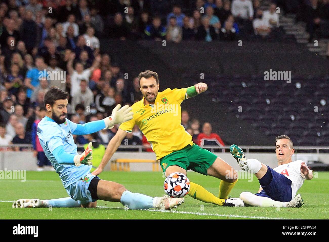 Giovani Lo Celso of Tottenham Hotspur (R) shot on goal is saved by Andre Ferreira, the goalkeeper of Pacos de Ferreira (L). UEFA Europa conference league play off match 2nd leg, Tottenham Hotspur v Pacos de Ferreira at the Tottenham Hotspur Stadium in London on Thursday 26th August 2021. this image may only be used for Editorial purposes. Editorial use only, license required for commercial use. No use in betting, games or a single club/league/player publications. pic by Steffan Bowen/Andrew Orchard sports photography/Alamy Live news Stock Photo