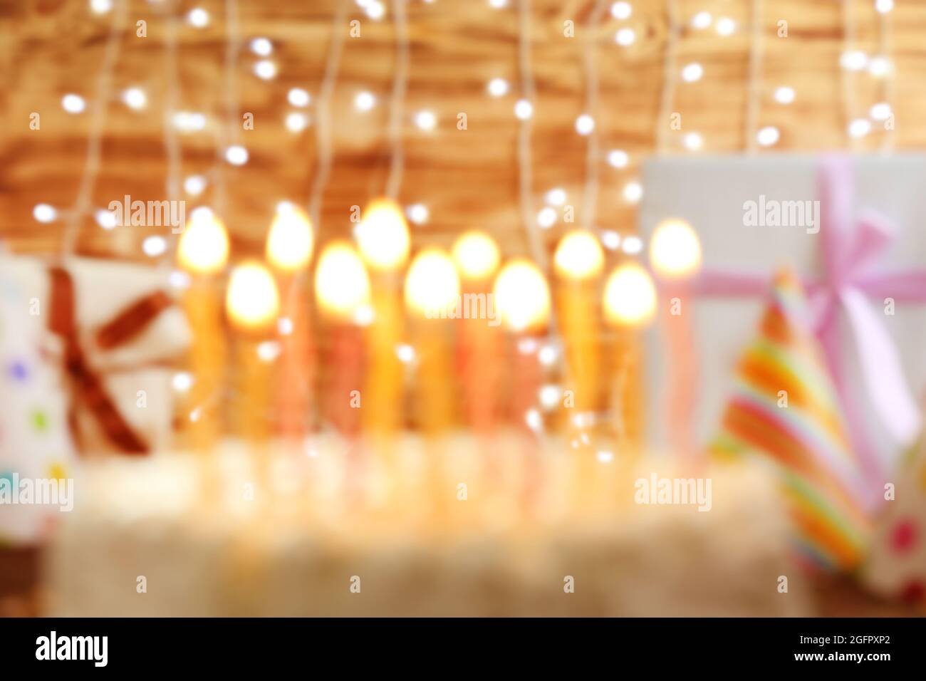 Blurred Birthday cake with candles on lights background Stock Photo - Alamy