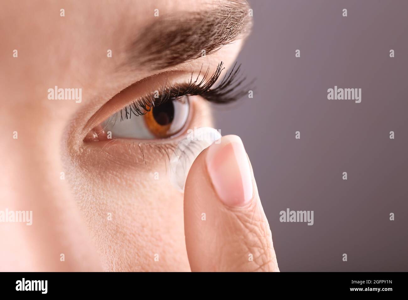 Woman putting contact lens in her eye, closeup Stock Photo Alamy