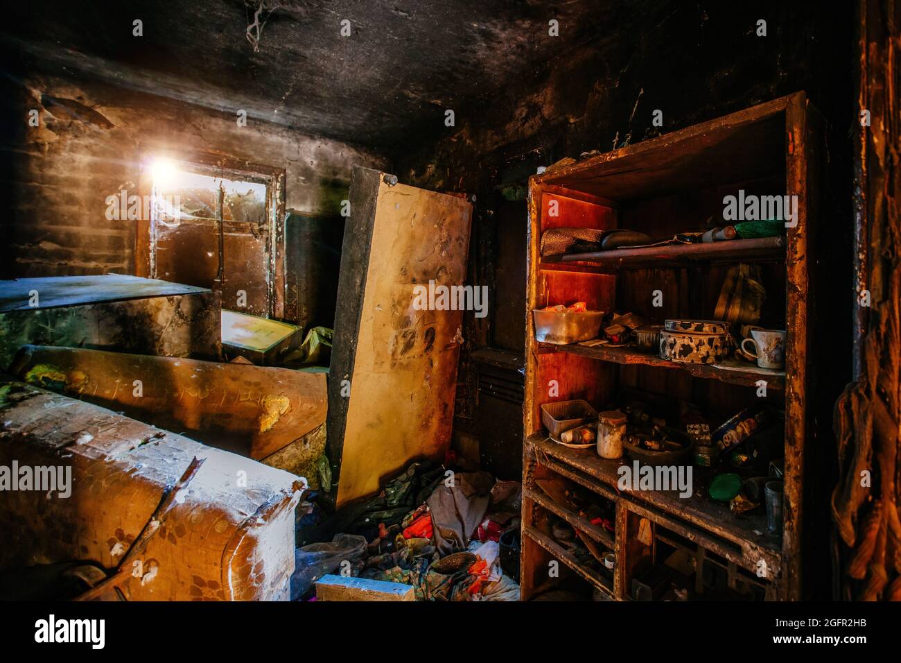 Burnt apartment house interior. Burned furniture and charred walls in
