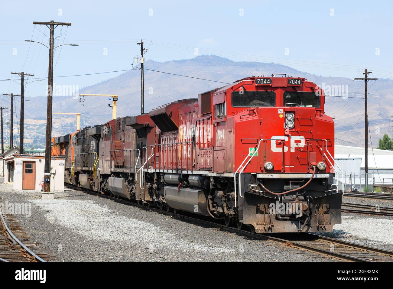 Wenatchee, WA, USA - August 25, 2021; A Canadian Pacific locomotive heads a line of engines from Norfolk Southern and BNSF at Wenatchee Washington Stock Photo
