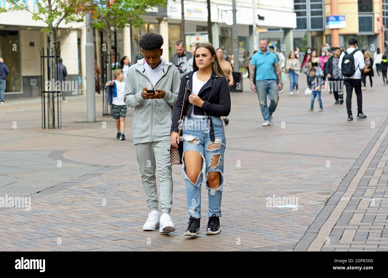 Couple of different race, out together, ripped jeans. Stock Photo