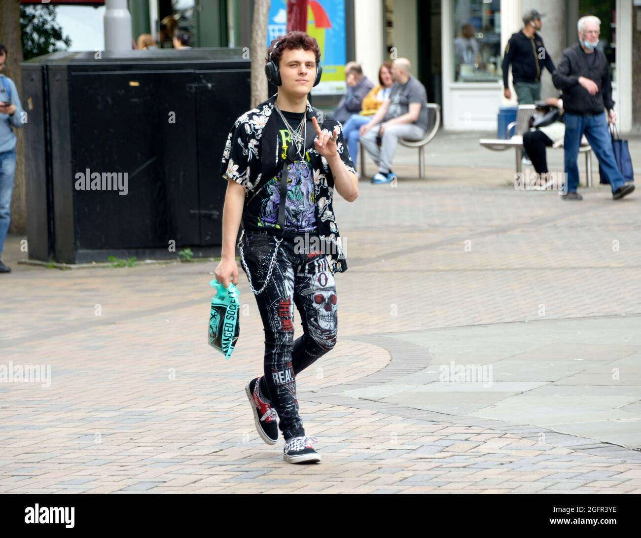 Trendy young man, in black with patterns, headphones Stock Photo