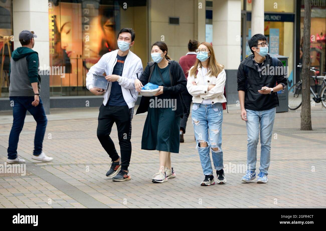 Group of Chinese people in Nottingham, still using masks in August 2021. Stock Photo