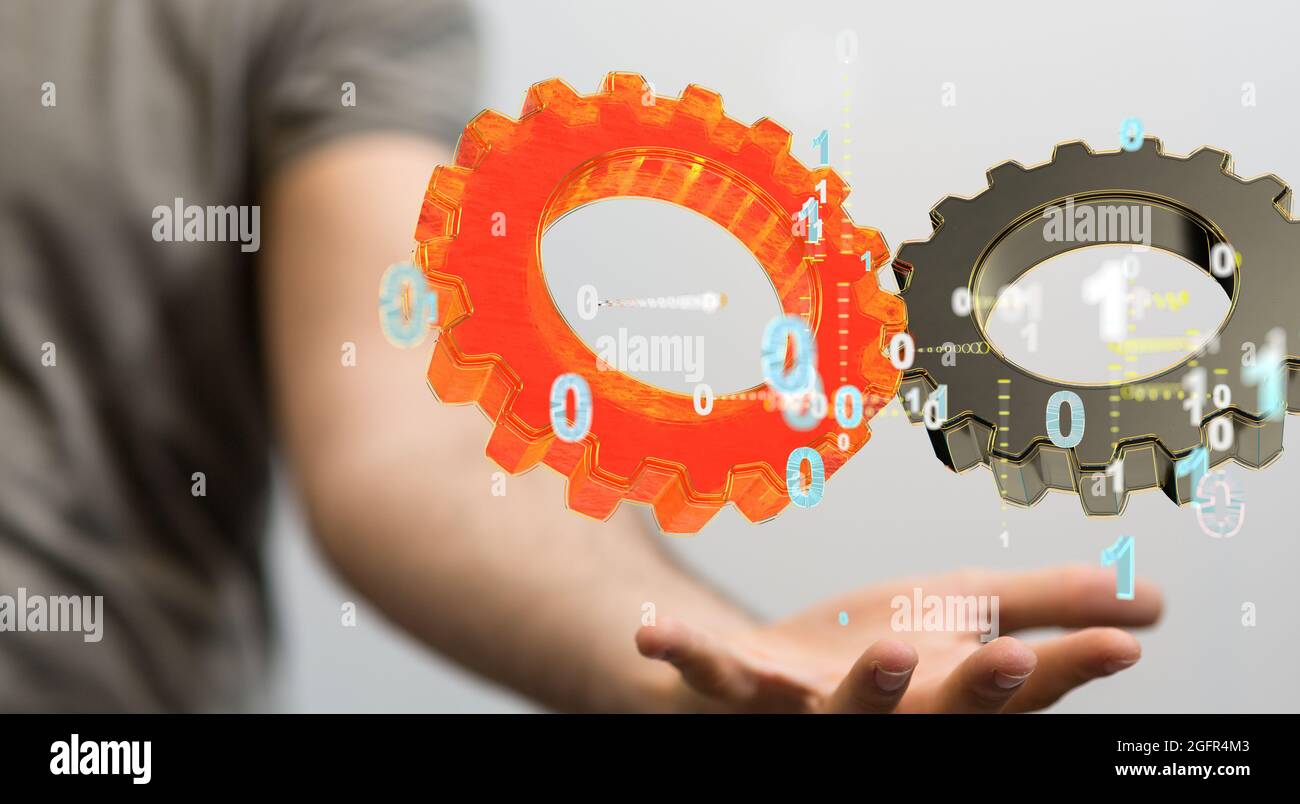 Person presenting the virtual projection of gears surrounded by 1s and 0s Stock Photo