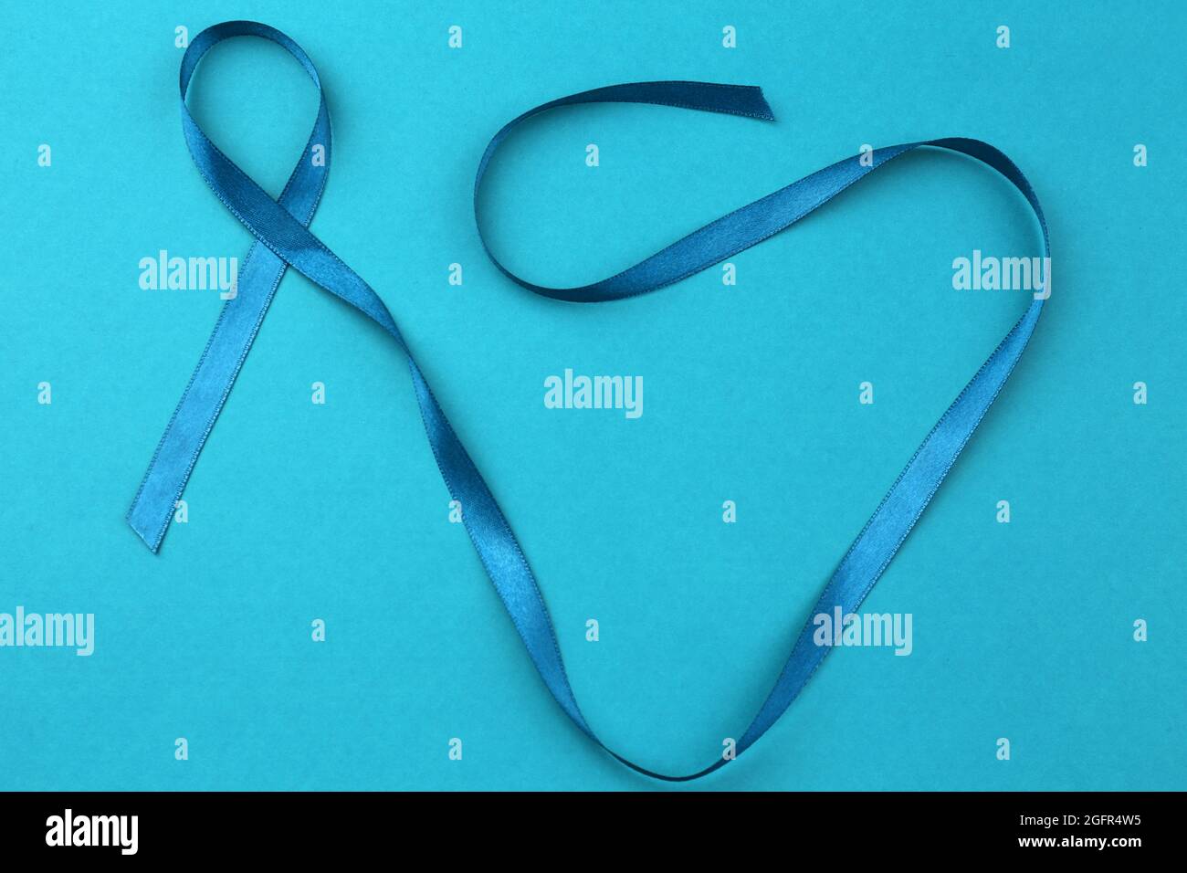 Seagreen ribbon on color background. Ovarian cancer and gynecological