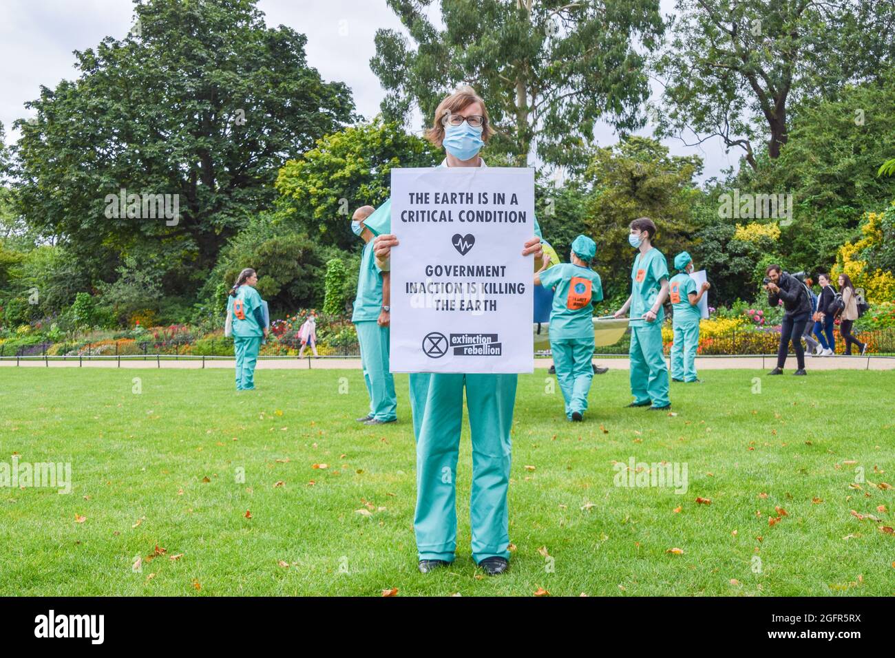 London, UK. 26th Aug, 2021. A protester holds a placard which says Government Inaction is Killing the Earth during the demonstration in St James's Park.Extinction Rebellion protesters marched from Hyde Park to the Department for Business, Energy and Industrial Strategy as part of their two-week campaign, Impossible Rebellion, calling on the UK Government to act meaningfully on the climate and ecological crisis. (Photo by Vuk Valcic/SOPA Images/Sipa USA) Credit: Sipa USA/Alamy Live News Stock Photo