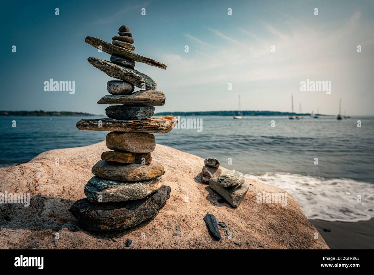 Balancing rocks overlook the ocean Stock Photo - Alamy