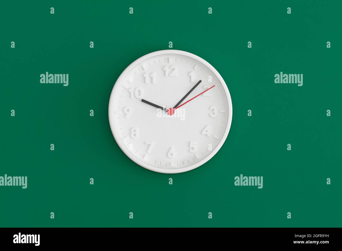 White wall Clock on gree background. Stock Photo