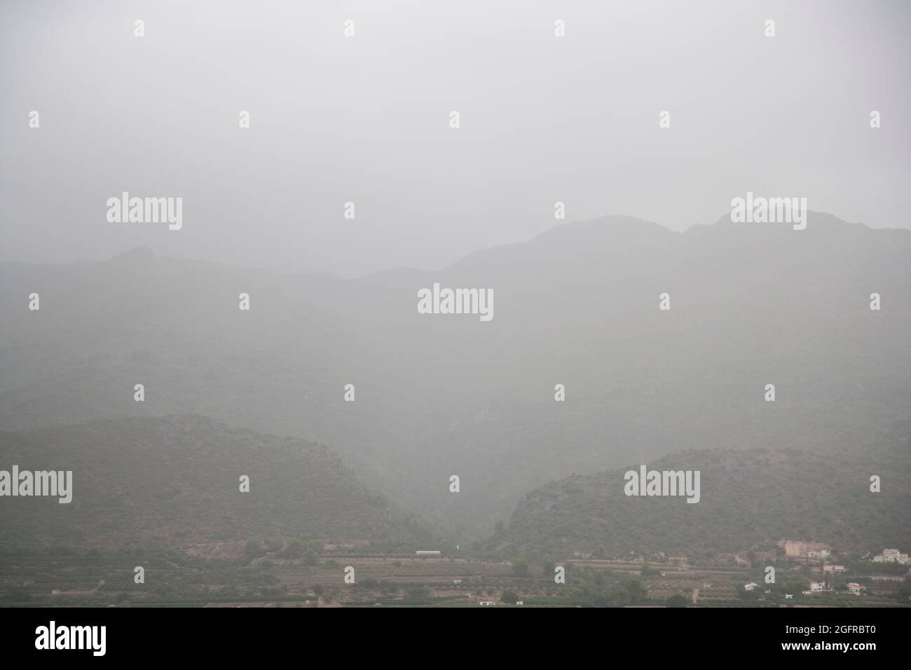Mist and low cloud around mountains in summer, near Orba, Alicante, Spain Stock Photo