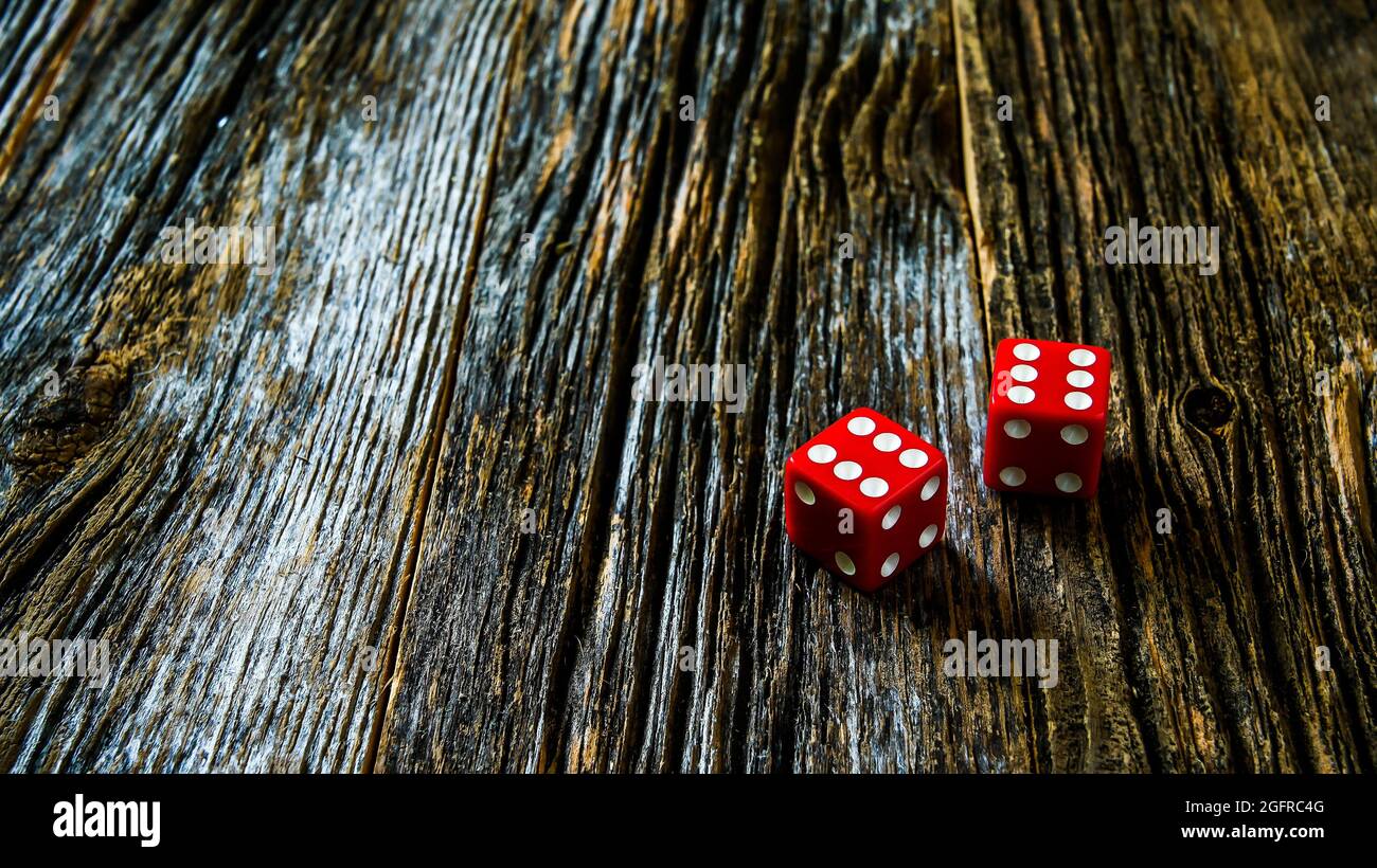 Two red dice on rustic wooden table with copy space Stock Photo