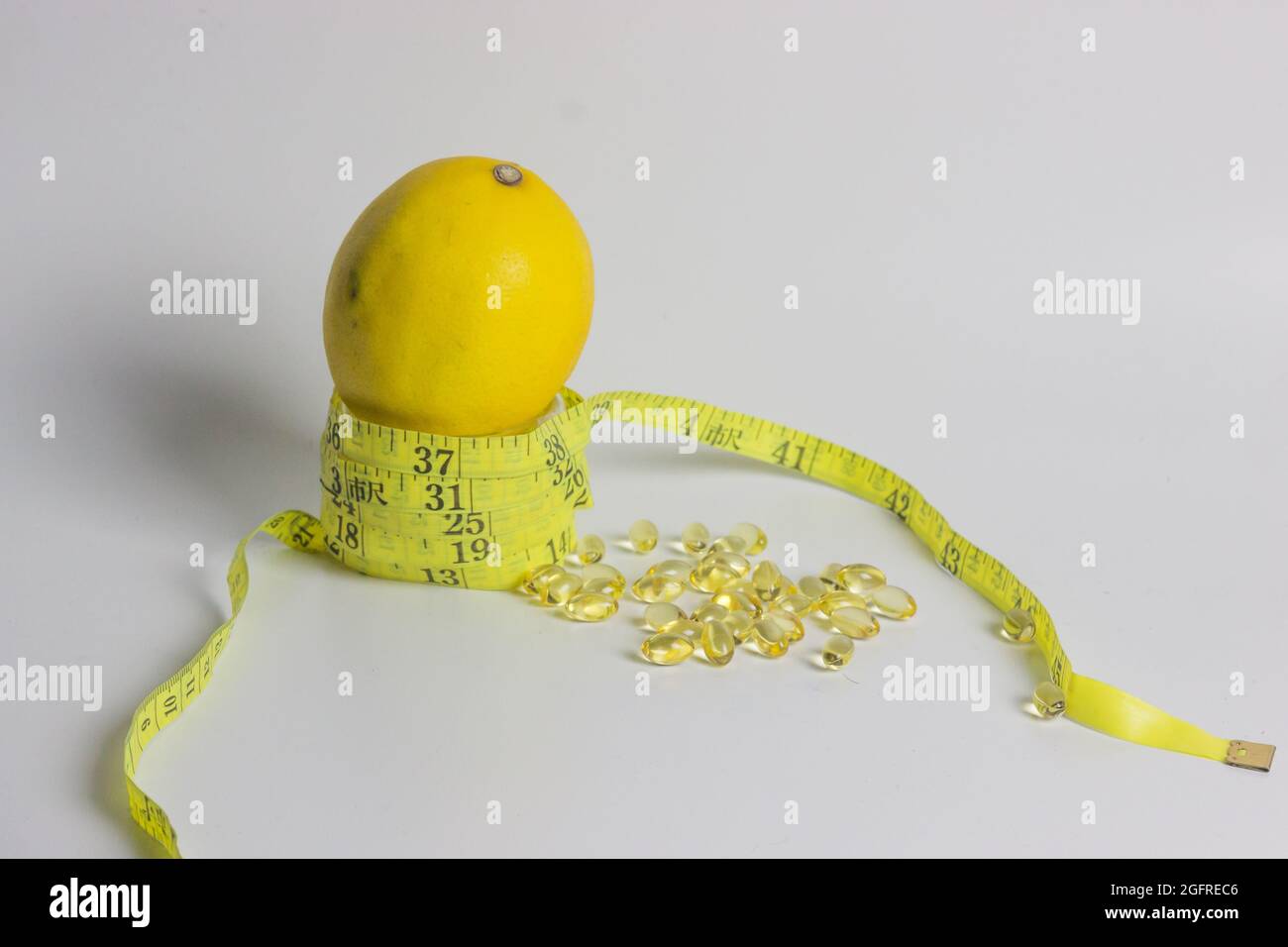 lemon and measuring tape for slimming and healthy concept Stock Photo