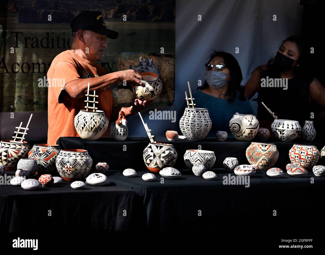 Traditional potters from Acoma Pueblo in New Mexico display their pottery at the annual Santa Fe Indian Market in New Mexico. Stock Photo