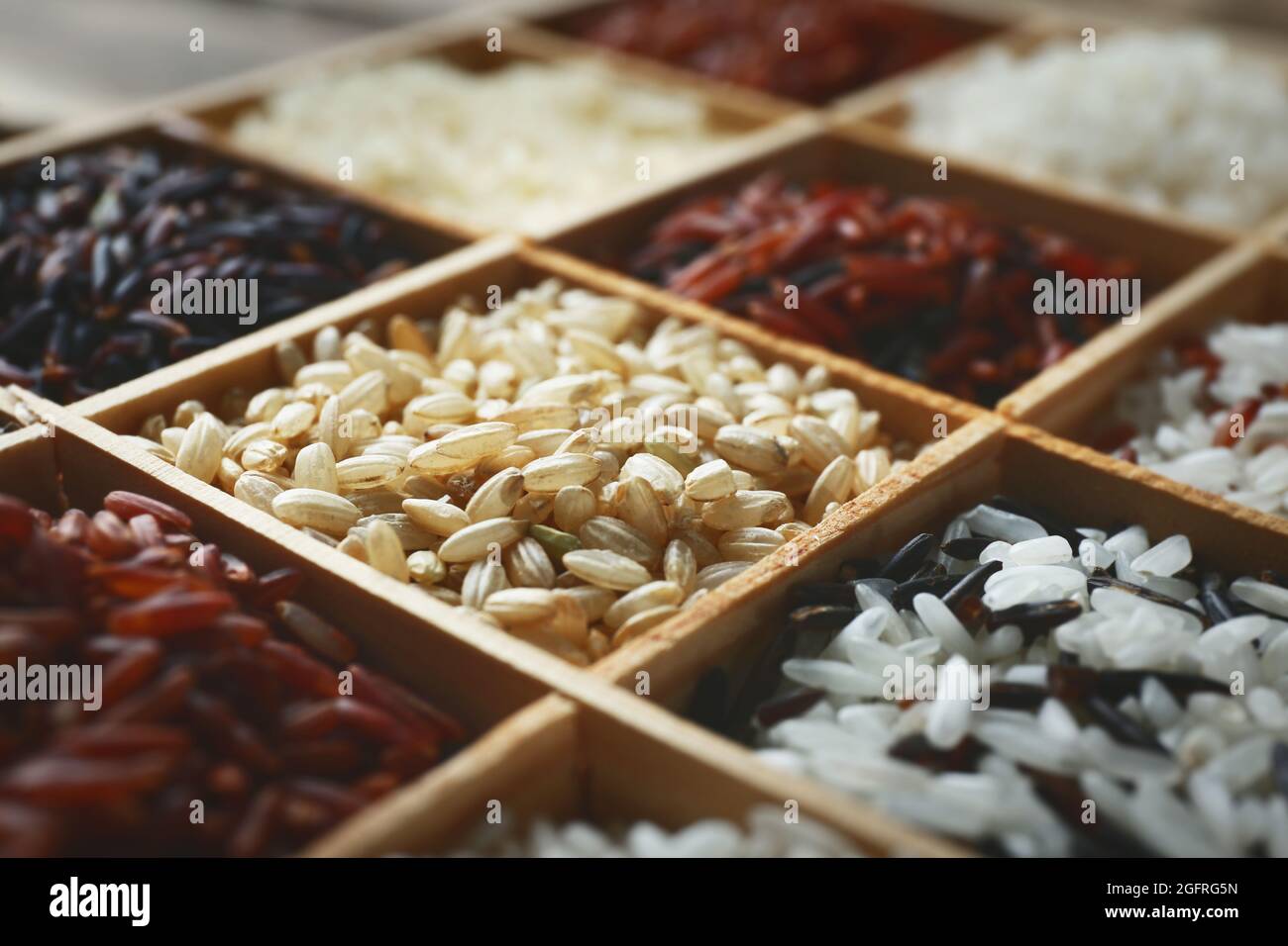 Different types of rice in wooden boxes closeup Stock Photo - Alamy