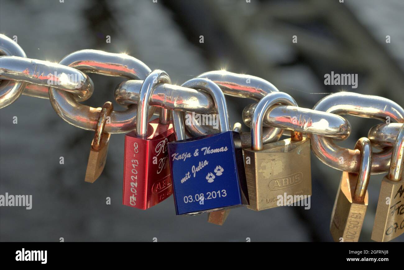 BREMEN, GERMANY - Aug 21, 2021: Locks on a chain with names and dates in memory of love Stock Photo