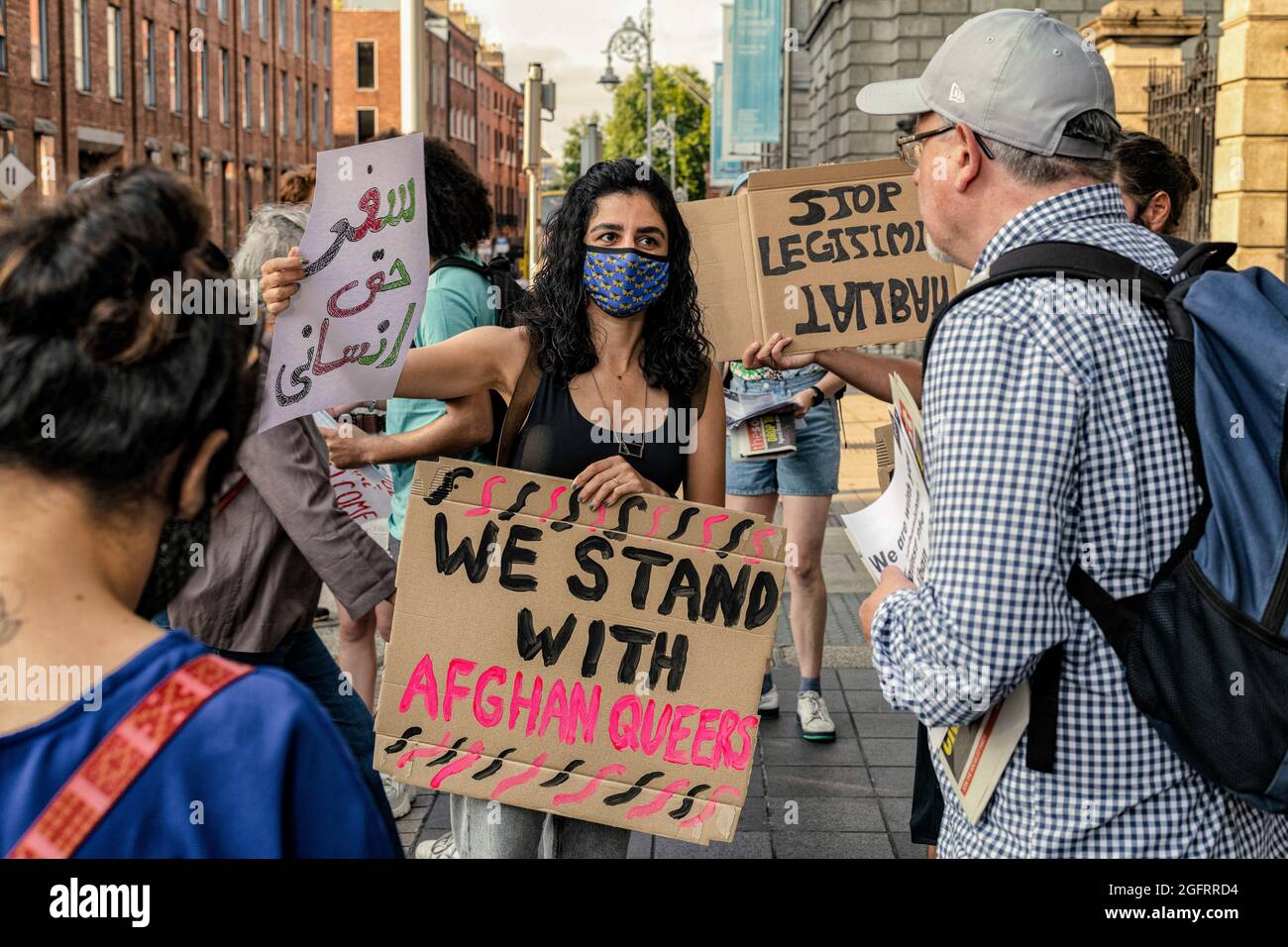 Protesters hold placards during the demonstration.A group of protestors gathered in front of Leinster House, the Irish parliament, in Dublin in solidarity with the Afghan people and to call for the Irish government to increase the number of refugees the country will pledge to grant visas to which is currently proposed at just under 200. The demonstration was organized by United against Racism group and was joined by other activists and groups such as ROSA and Le Chéile and was addressed by speaker Paul Murphy, TD for People Before Profit among others. Stock Photo