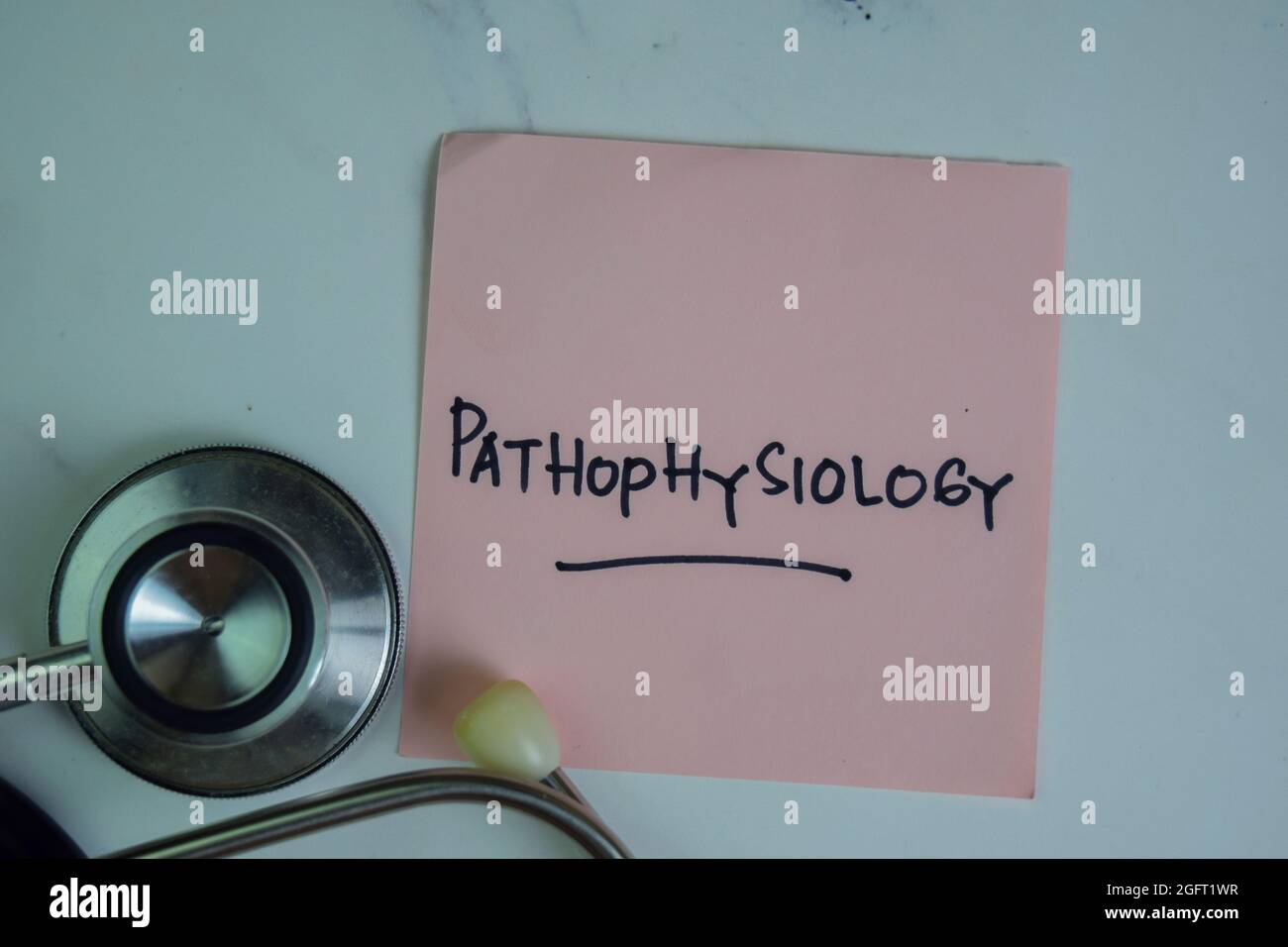 Pathophysiology write on sticky notes isolated on Wooden Table. Stock Photo