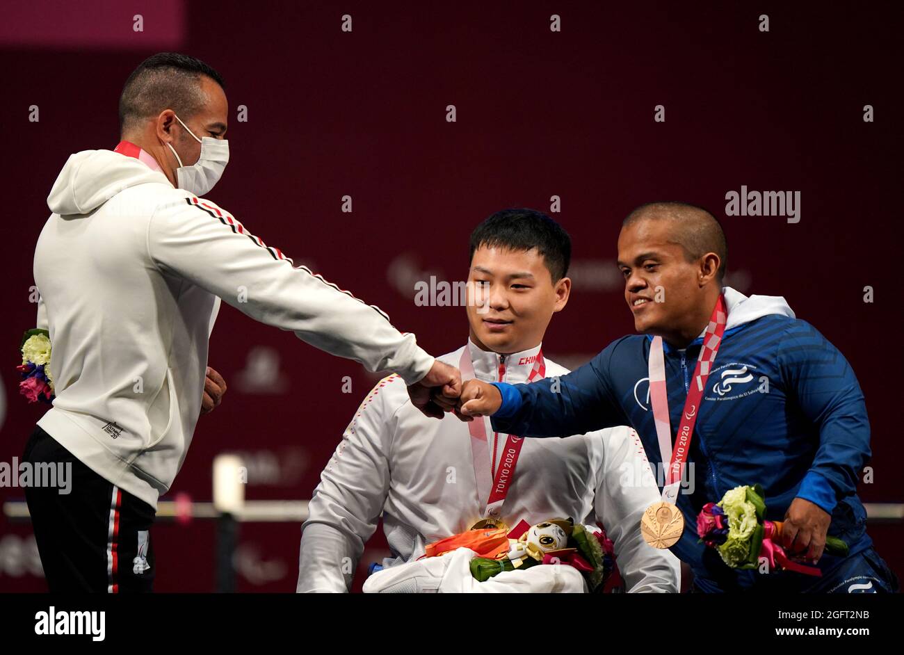 Egypt's Sherif Othman with the silver medal (left), China's Yongkai Qi with the gold (centre) and El Salvador's Herbert Aceituno with the bronze after the Men's -59 kg Final at the Tokyo International Forum during day three of the Tokyo 2020 Paralympic Games in Japan. Picture date: Friday August 27, 2021. Stock Photo
