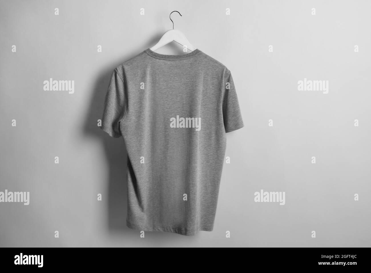 Blank grey t-shirt on light background Stock Photo - Alamy