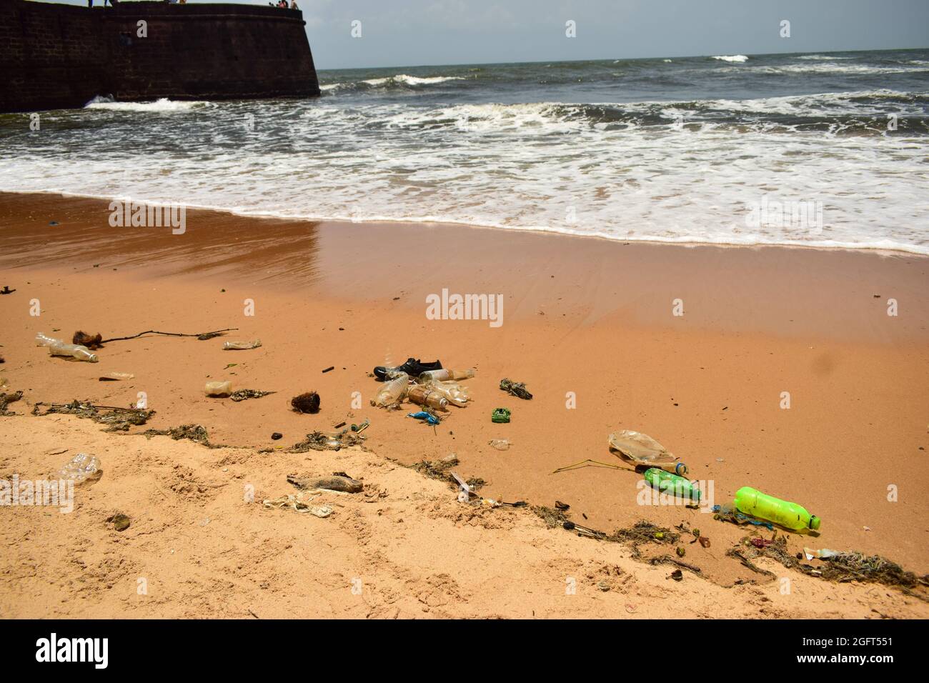 Ocean-Sea Waves Beach Sand and Garbage Stock Photo