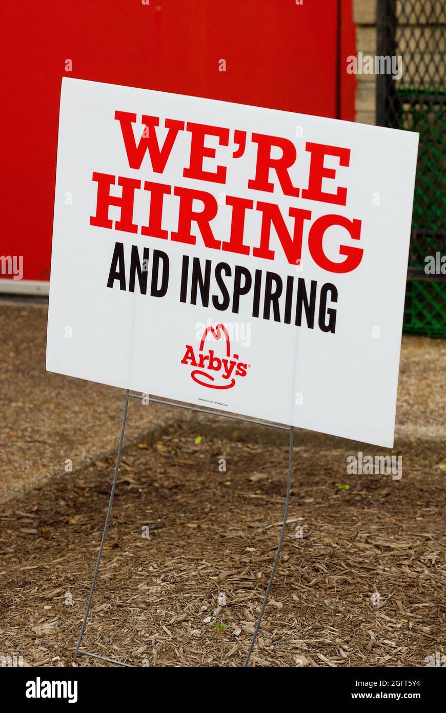 Chantilly, Virginia, USA - May 27, 2021: Close-up image of a sign posted outside an Arby's Restaurant drive-through advertising 'We're Hiring'. Stock Photo