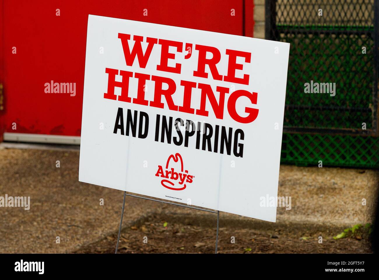 Chantilly, Virginia, USA - May 27, 2021: Close-up image of a sign posted outside an Arby's Restaurant drive-through advertising 'We're Hiring'. Stock Photo
