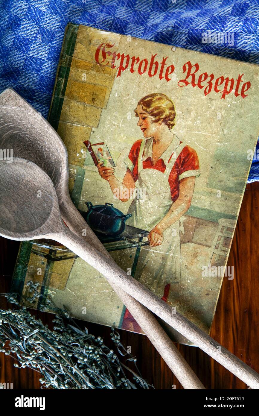 antique cookbook with wooden spoon Stock Photo