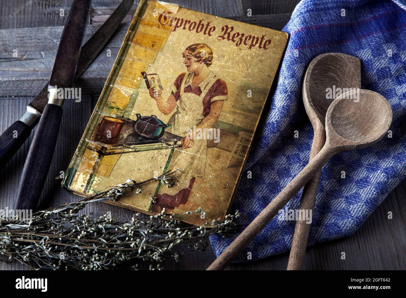 antique cookbook with wooden spoon Stock Photo
