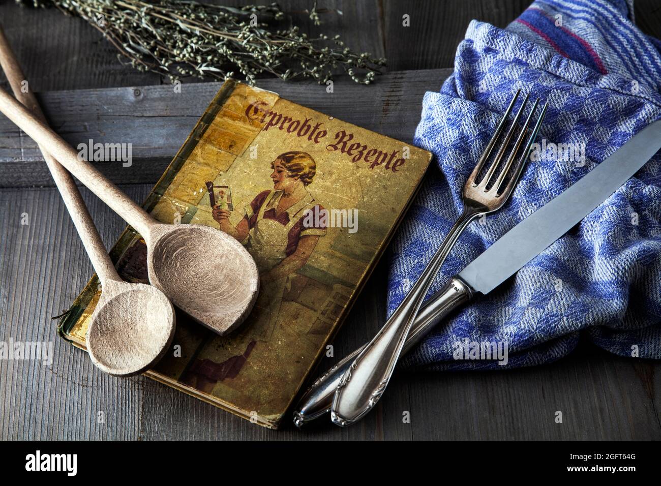 antique cookbook with wooden spoon and cuterly Stock Photo