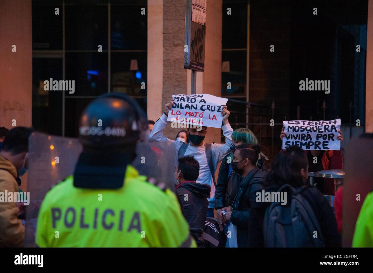 Demonstrators hold a sign that reads 'Who Killed Dilan Cruz? Police did' during a rally organized by students of the Universidad Distrital, after a few days back Esteban Mosquera, a social leader and community member was killed two years after loosing his eye on a police brutality case, in Bogota, Colombia on August 26, 2021. Stock Photo