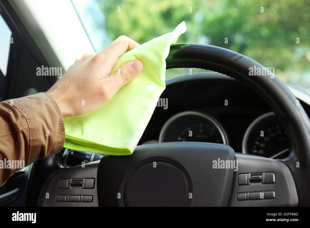 Man wiping interior of luxury car Stock Photo Alamy