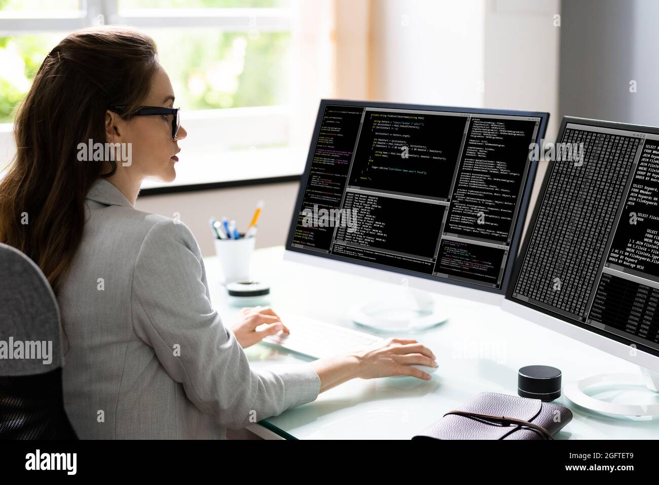 Programmer Woman Coding Software On Computer At Desk Stock Photo - Alamy
