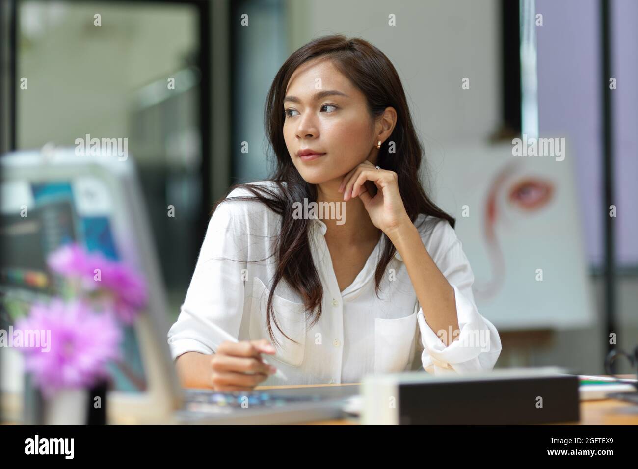 Thoughtful creative graphic designer, thinks about work, looking ...